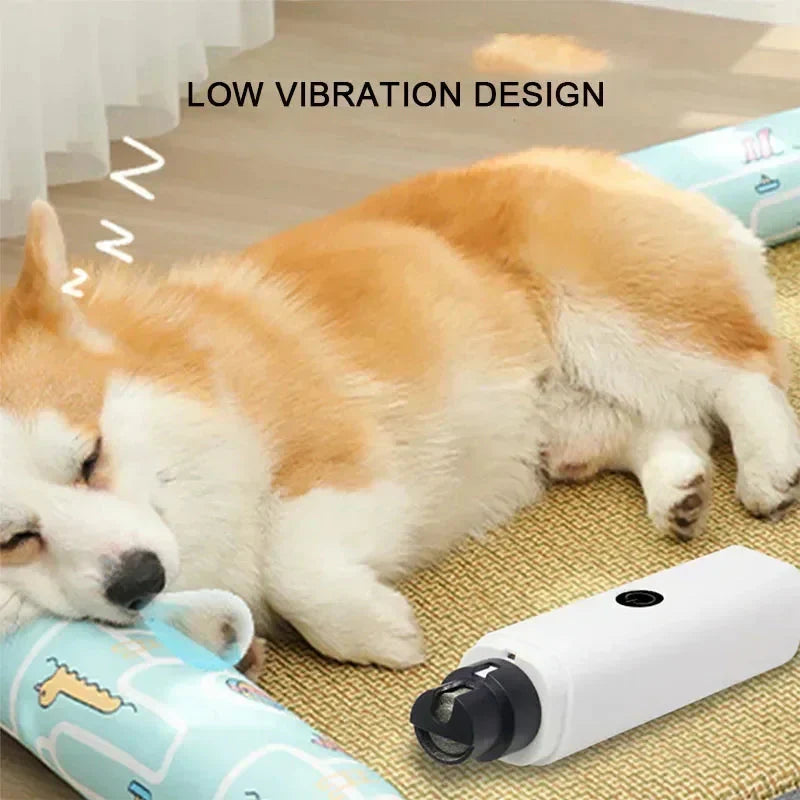 White electric pet nail grinder resting near a sleeping puppy on a yellow mat