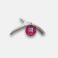 Light gray deer antler dog chew with three-prong shape and red brand tag