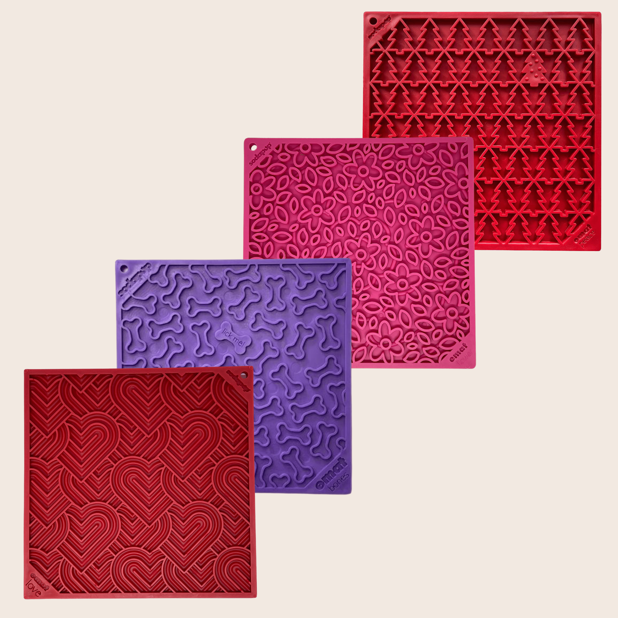 Assorted dog lick mats with patterned silicone surfaces in red and purple