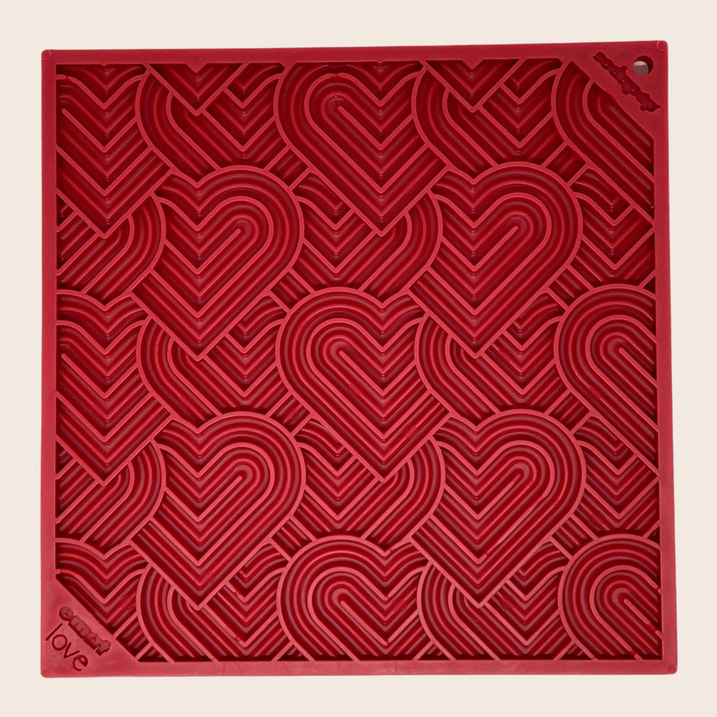 Red dog lick mat with heart swirl pattern and corner mounting holes