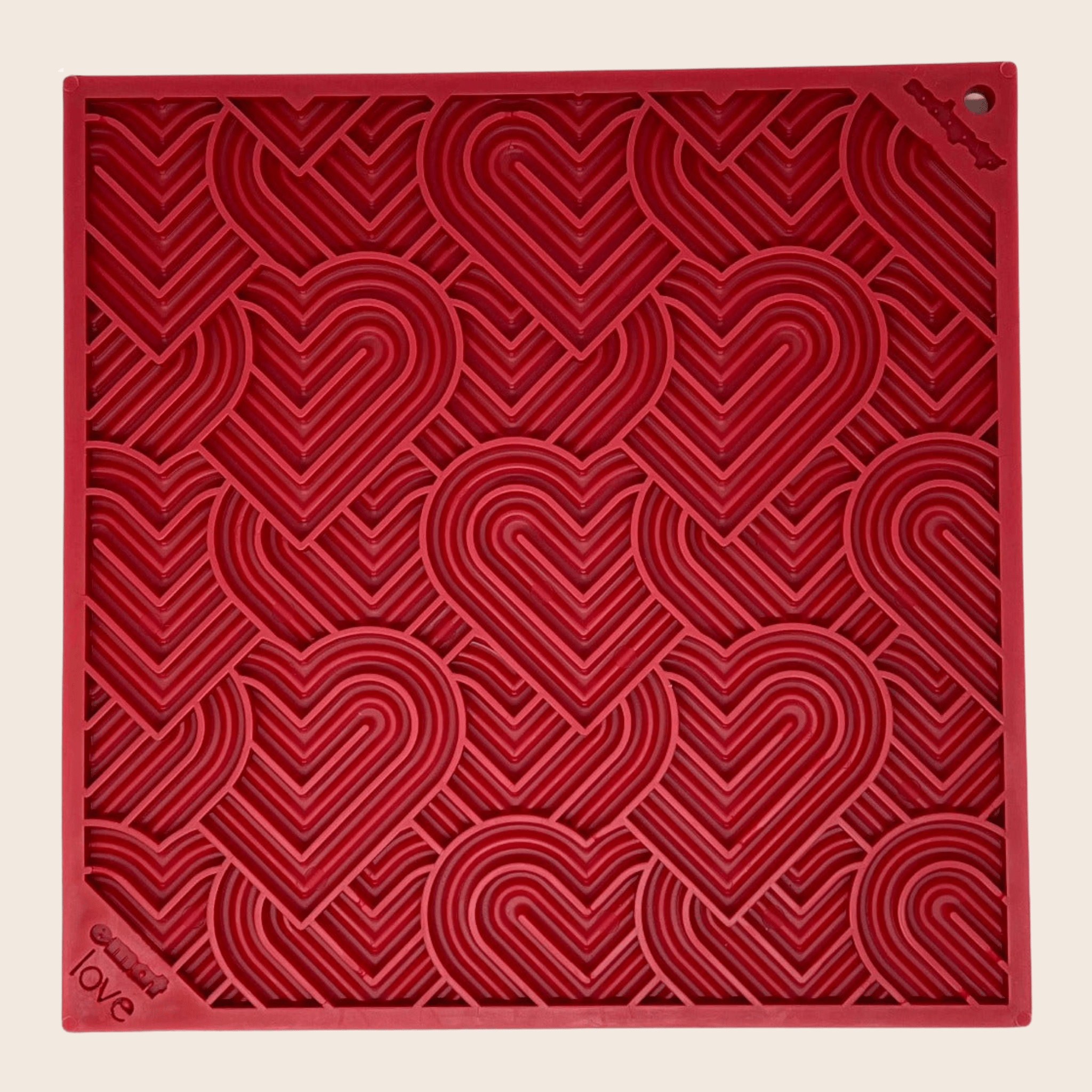 Red dog lick mat with heart swirl pattern and corner mounting holes