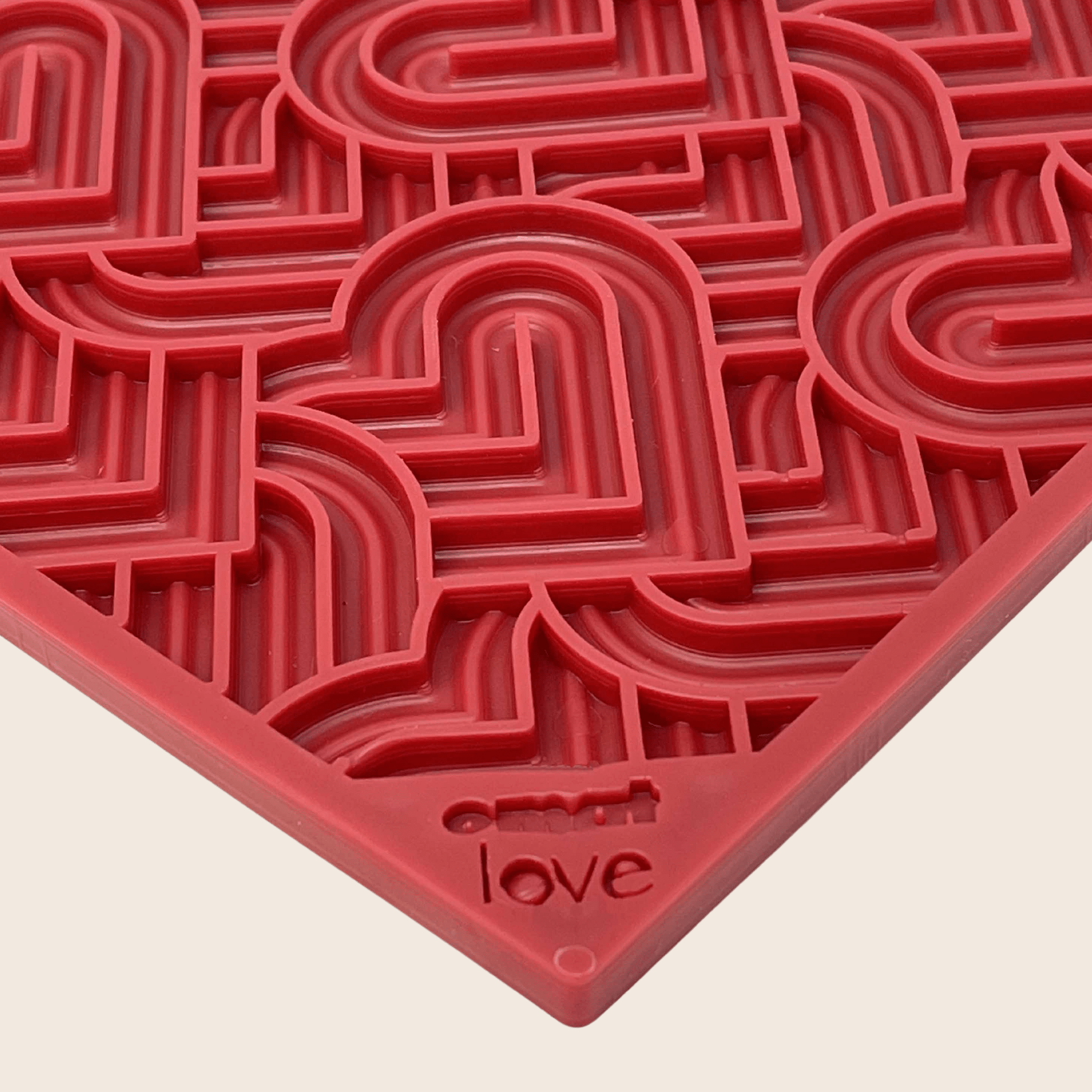 Red dog lick mat with heart maze pattern and “love” text on corner