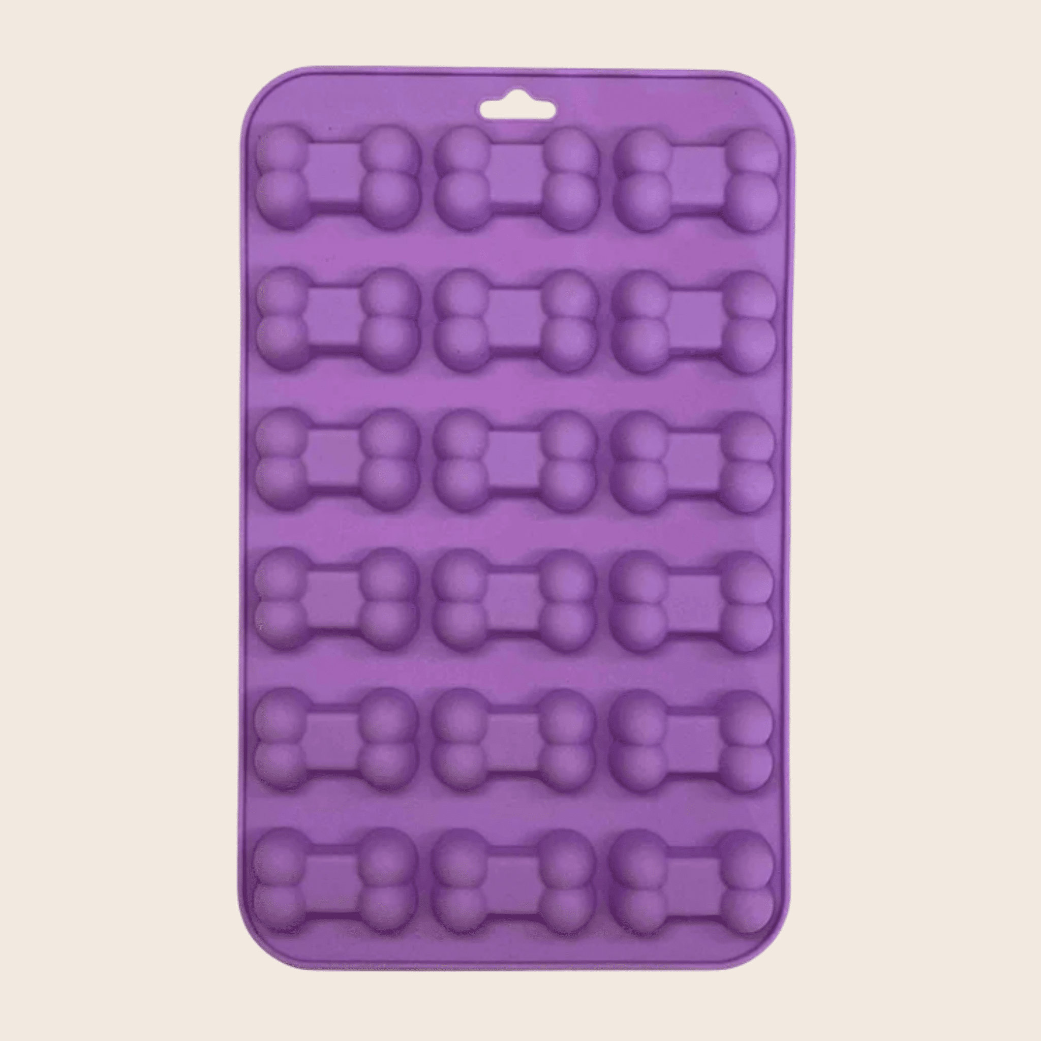 Silicone pet treat mold tray in purple with bone-shaped cavities