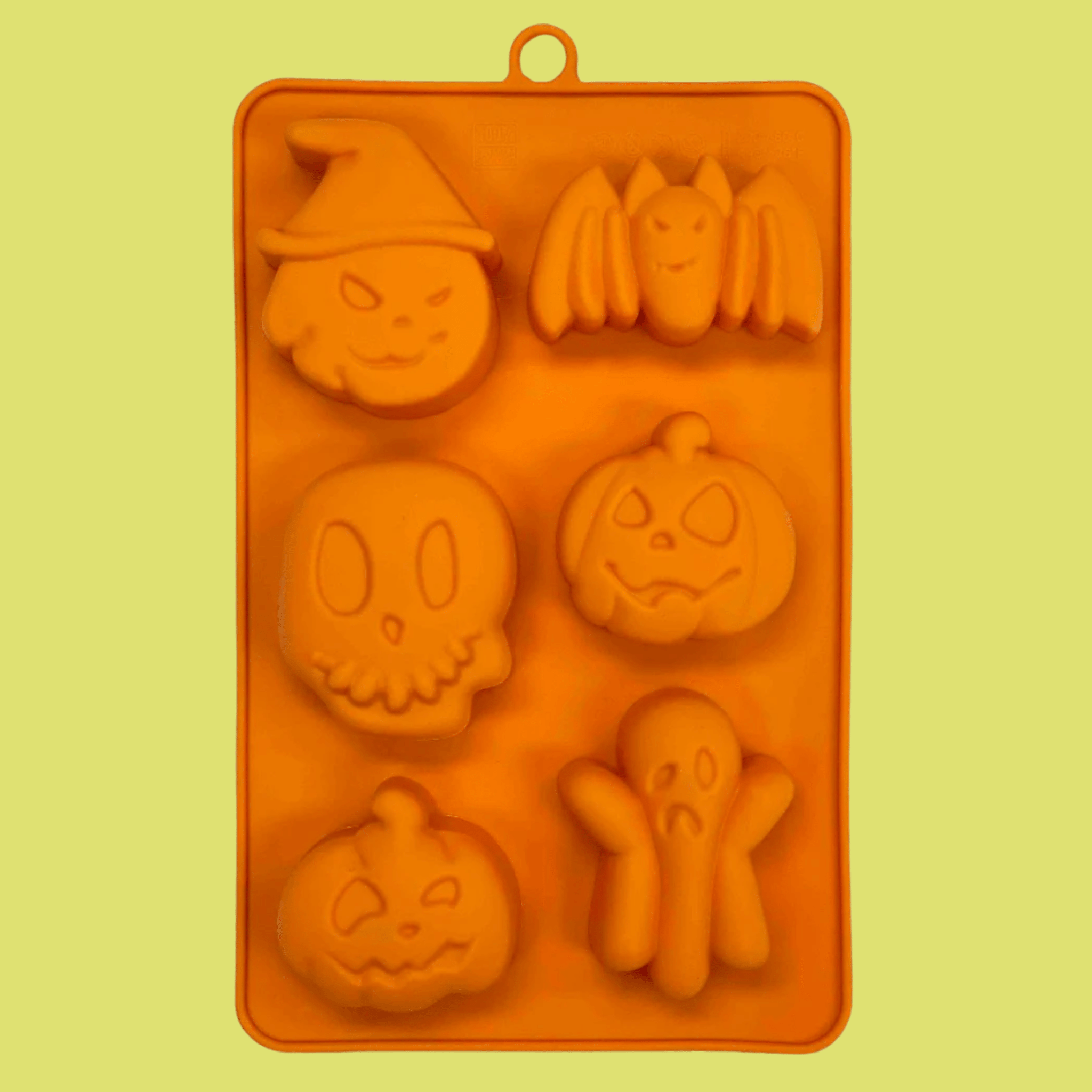 Orange silicone pet treat mold tray with Halloween pumpkin, ghost and cat face shapes