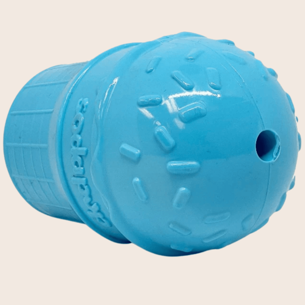 Blue ice cream dog treat dispenser end view with raised texture and side hole.