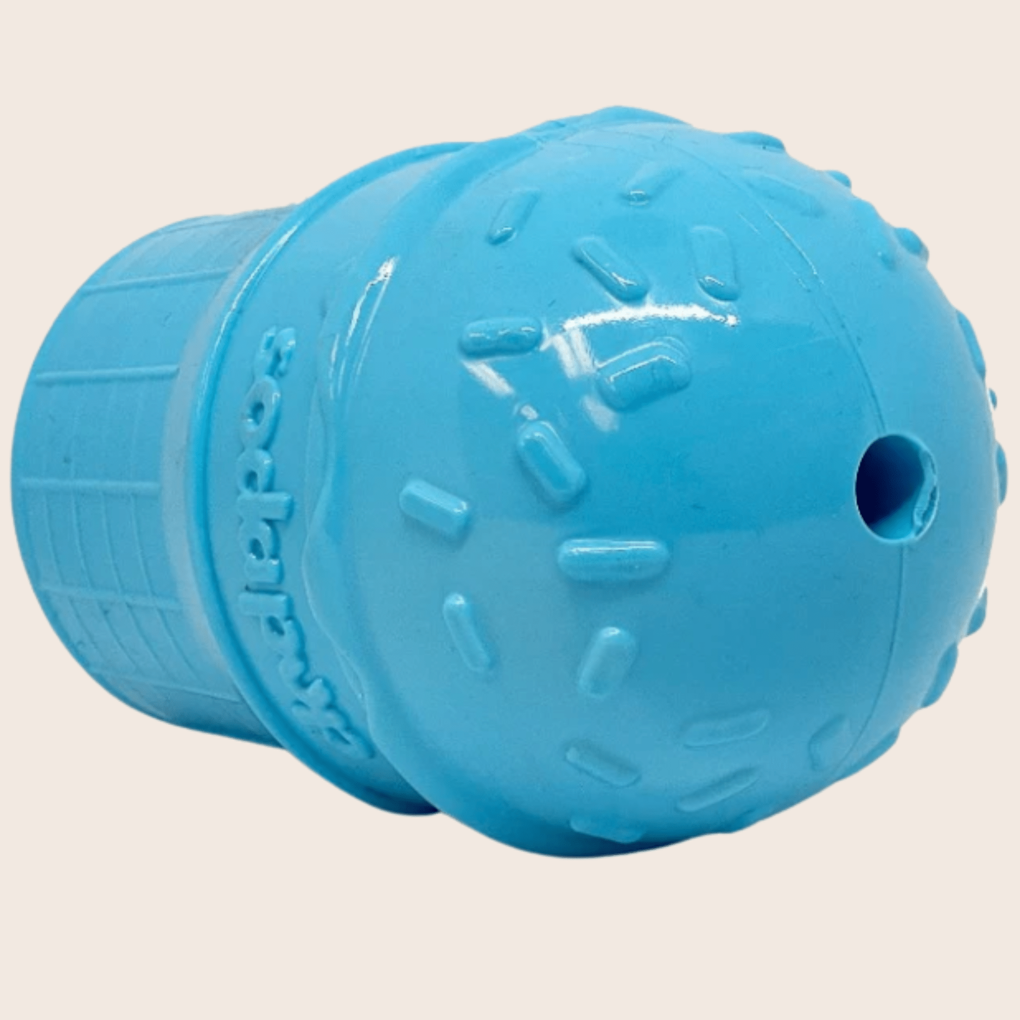 Blue ice cream dog treat dispenser end view with raised texture and side hole.