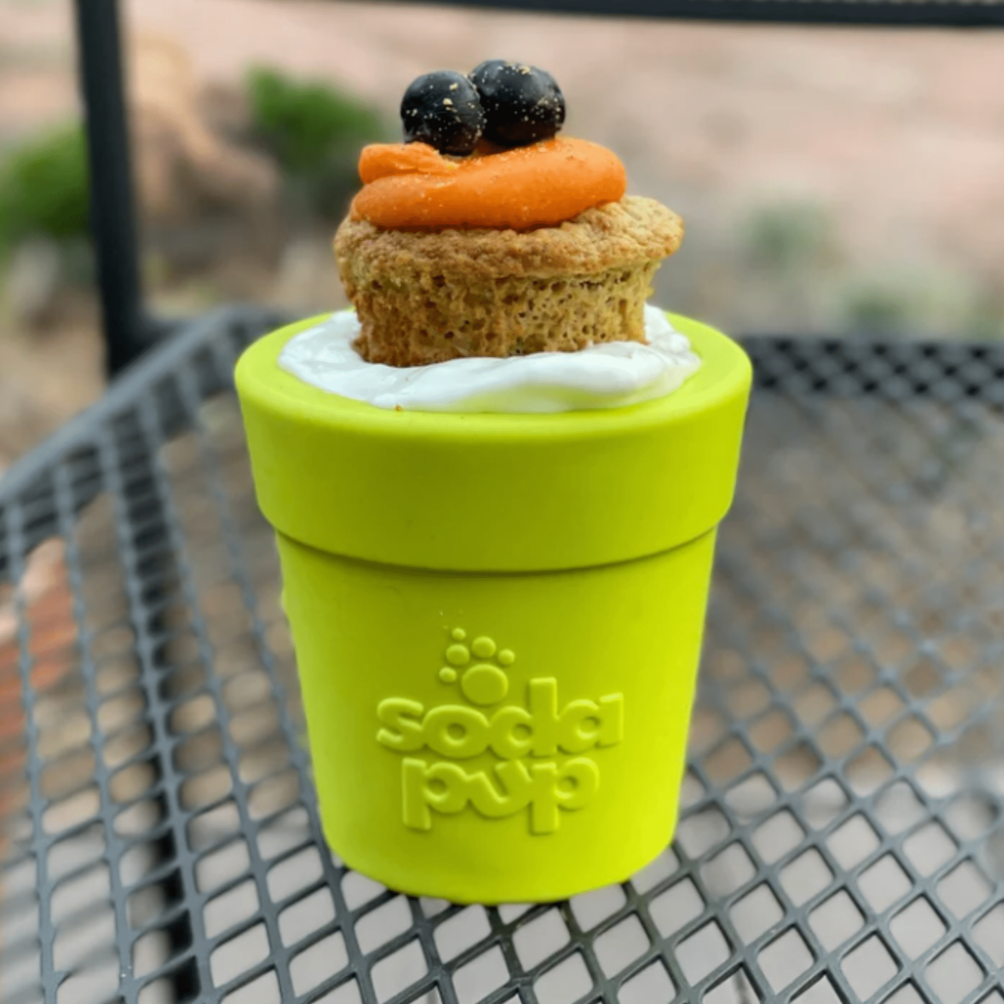 lime green dog treat dispenser with flower paw logo and flip-top lid