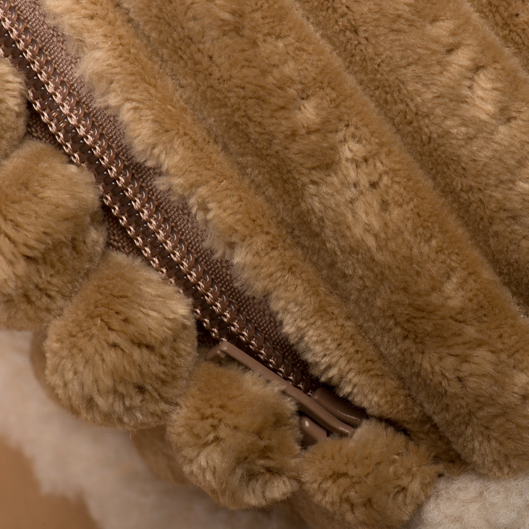 Khaki plush dog bed close-up showing zipper and furry fabric texture