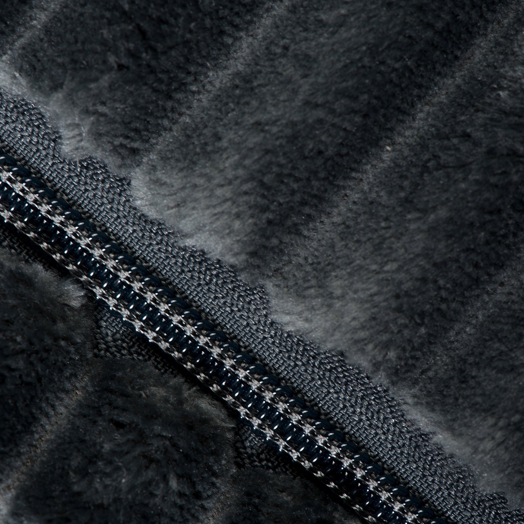 Steel blue plush dog bed close-up showing zipper and dark fabric texture