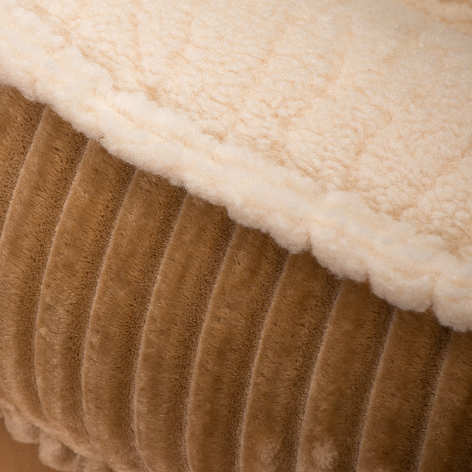 Khaki bolster dog bed close-up of plush top edge and ribbed side panel
