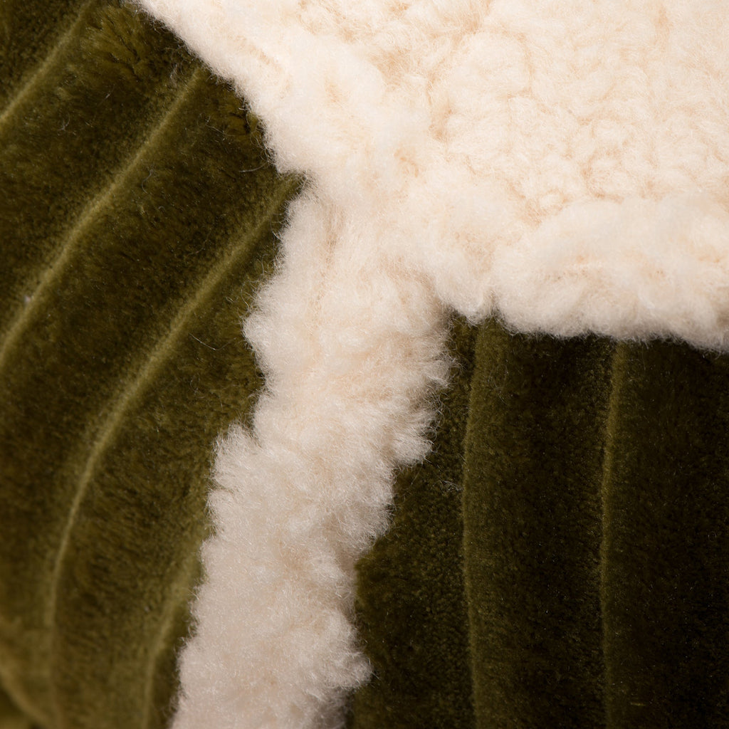 Bolster dog bed in olive green with thick white sherpa trim and ribbed bolster sides