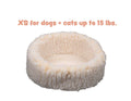 Round cream sherpa pet bed with plush raised rim
