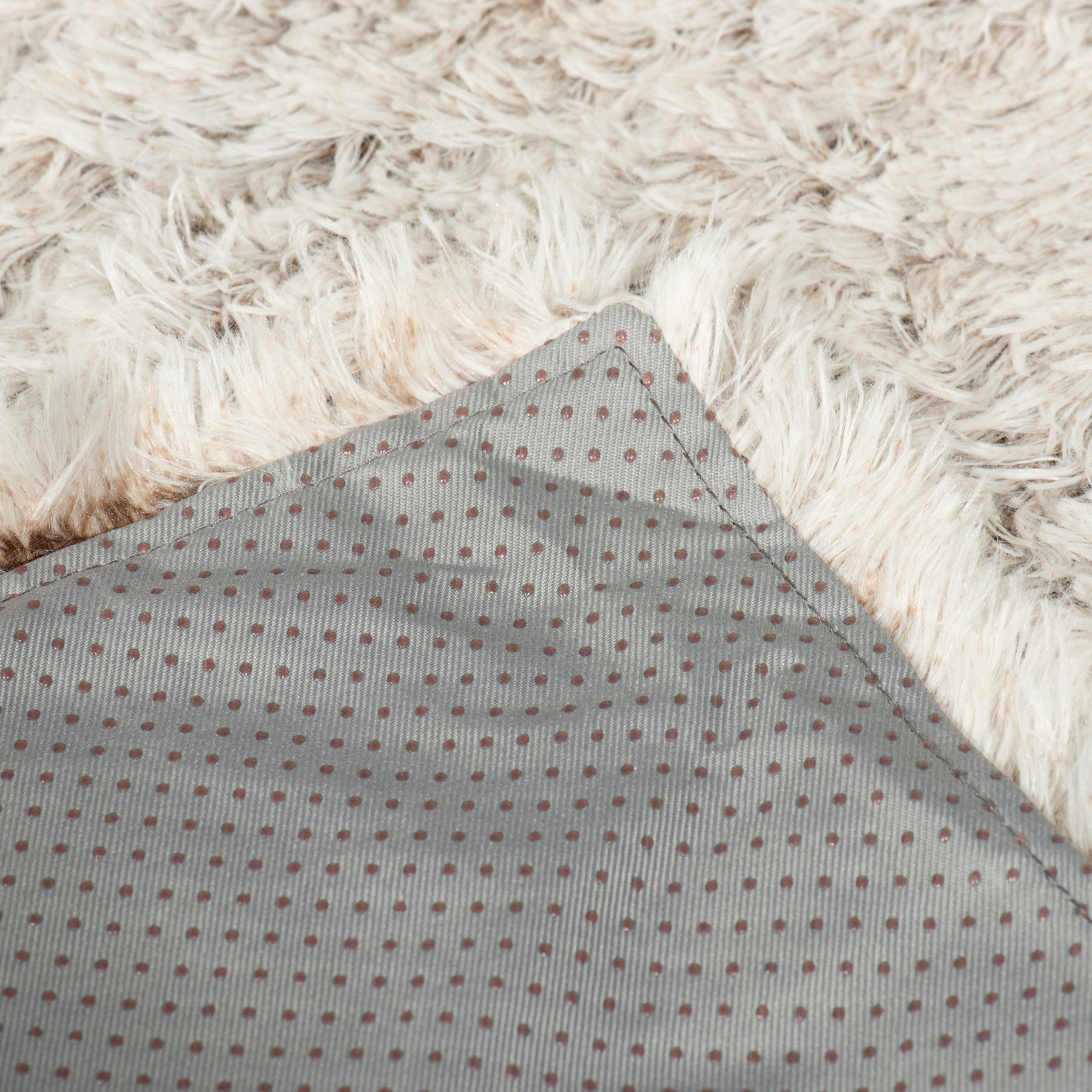 Zippered inner panel with gray dotted fabric under cream faux-fur edge