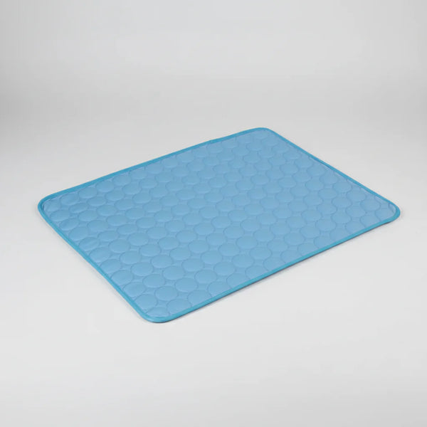 Blue cooling dog mat with textured hex pattern and padded edges