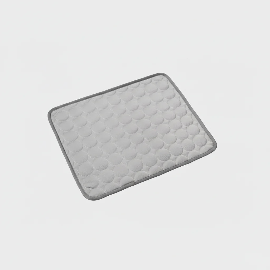Light gray cooling dog mat with hex-textured surface and dark stitched border