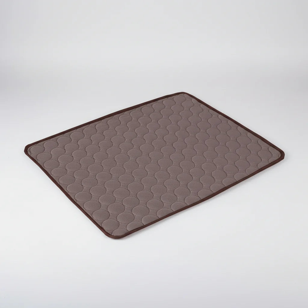 Brown cooling dog mat with hex-textured surface and dark stitched border