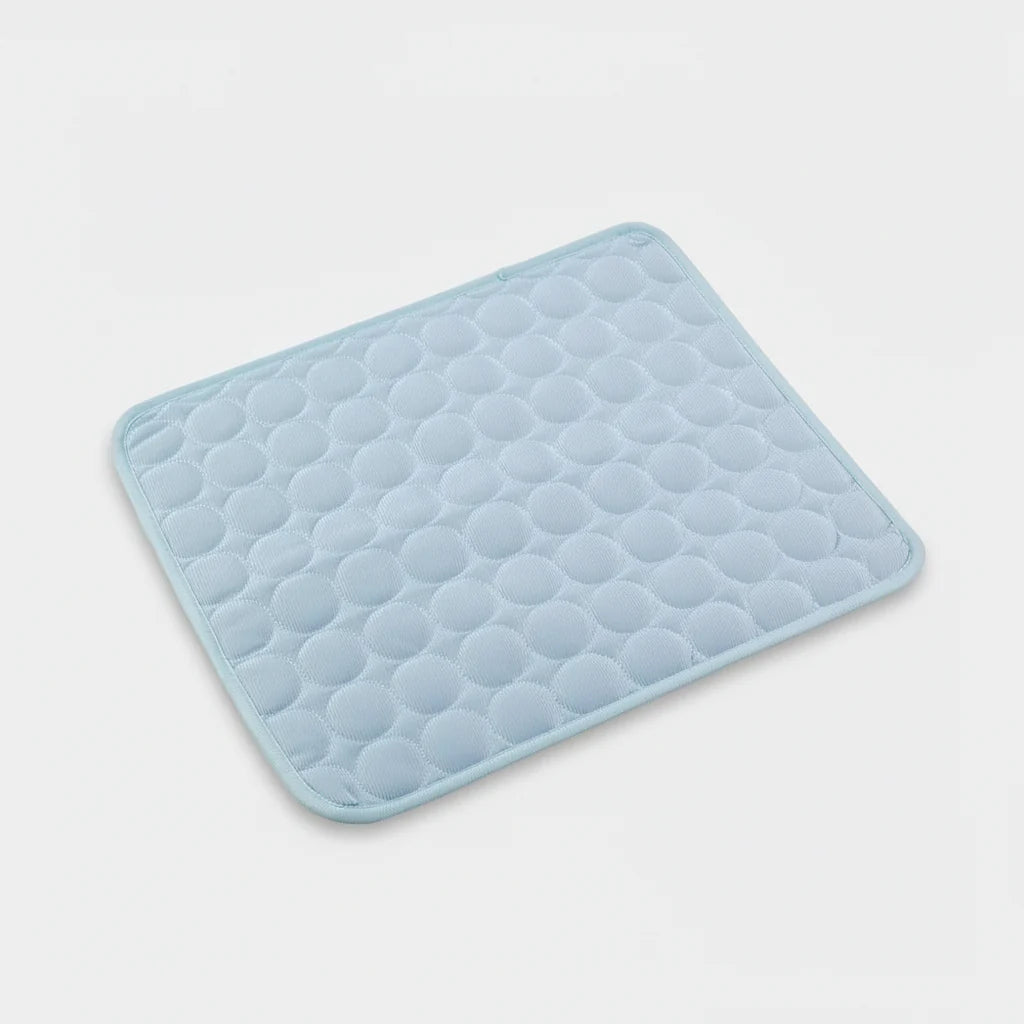 Light blue cooling dog mat with raised hex-textured surface and stitched border