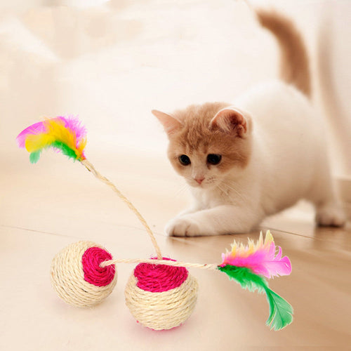 Sisal shuttlecock cat toy with cream sisal balls, pink and green feathers, and string